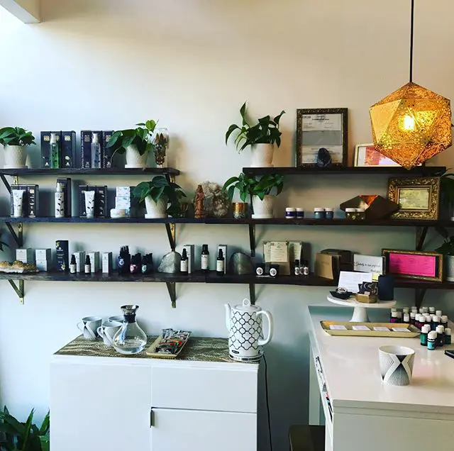 A cup of tea beside a new shipment of skin care products at the studio