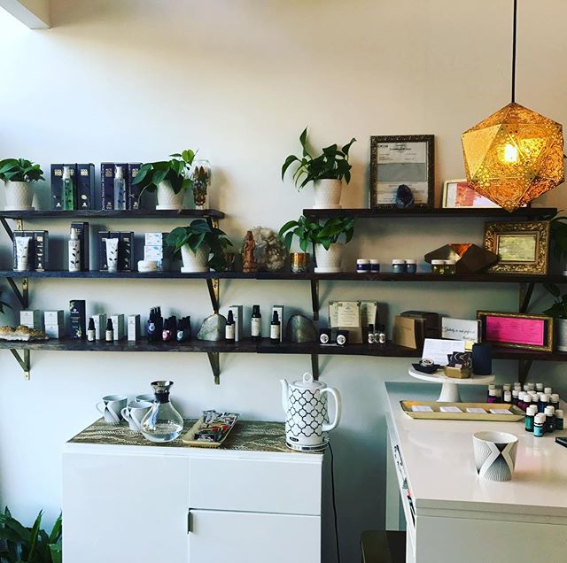 A cup of tea beside a new shipment of skin care products at the studio